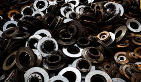 A pile of recycled metal brake discs showcasing industrial recycling.