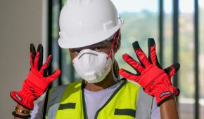Close-up of a construction worker wearing PPE and protective gear indoors. Ideal for safety and occupational content.
